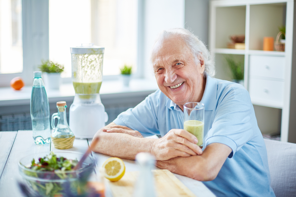 Senior man with glass of smoothie